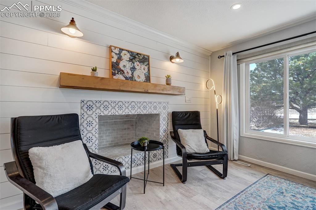 Image 3 of 31: Sitting area around the fireplace with views of the front range from the wi