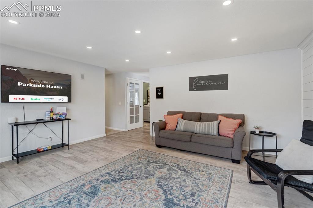 Image 4 of 31: Living area featuring recessed lighting and LVP flooring.