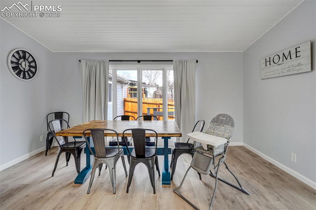 Image 8 of 31: Dining area that walks out to the deck and hot tub with LVP flooring and sh