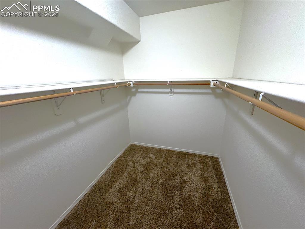 Image 12 of 49: Enormous Primary Bedroom Walk-in Closet