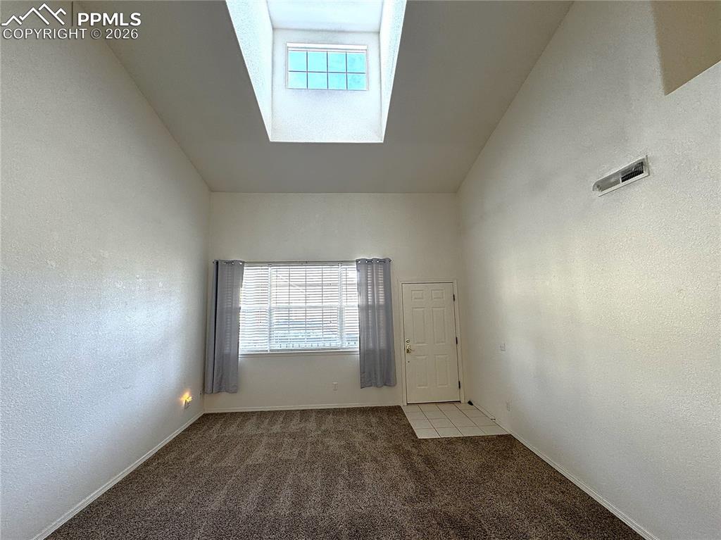 Image 3 of 49: High ceiling in Living Room with ample light from large Dormer Window