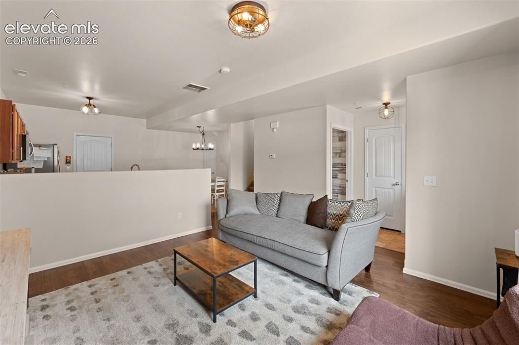 Image 9 of 32: Wood-finish flooring throughout, complemented by a semi-open floor plan