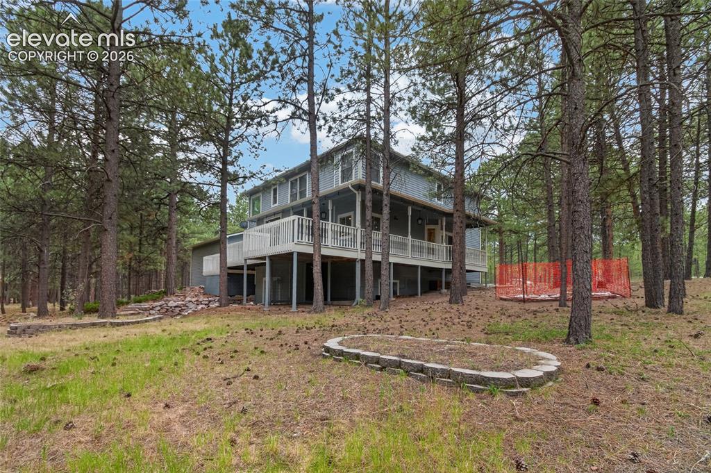 Image 10 of 46: Multi-level residence featuring a gray exterior and white railing accents, 