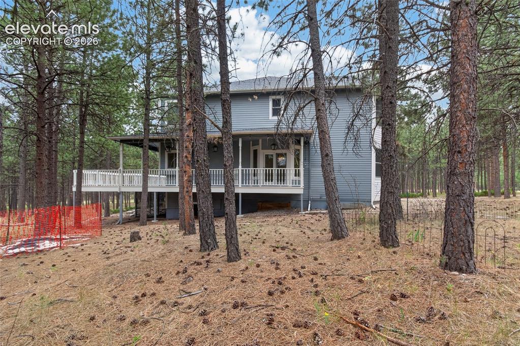 Image 9 of 46: Two-story house featuring blue horizontal siding and a white trim