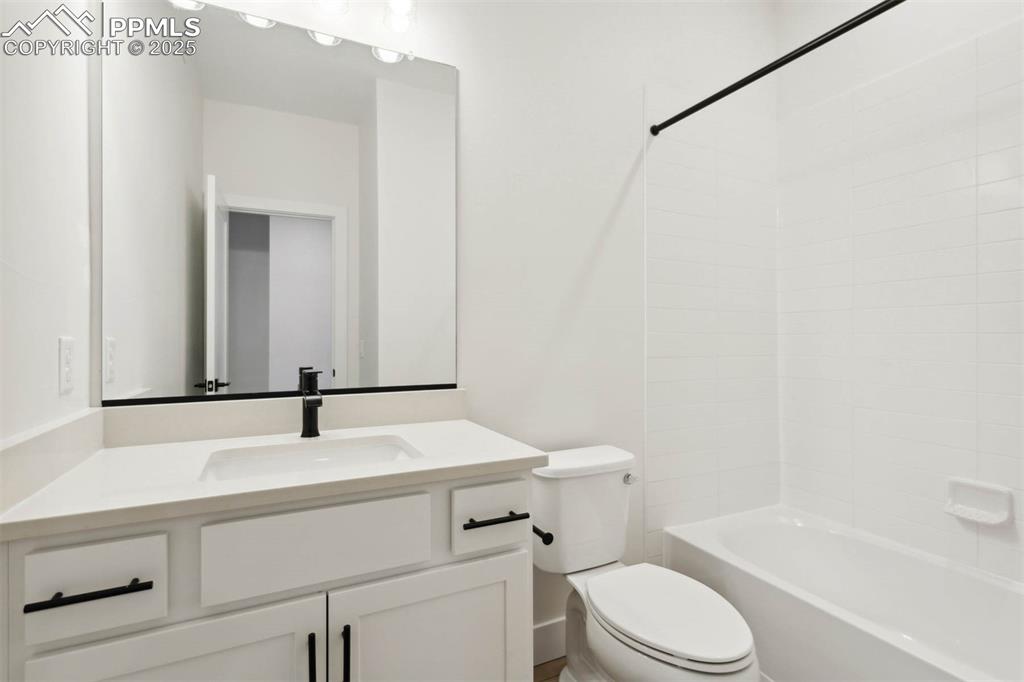 Image 8 of 15: Bathroom with tub / shower combination, toilet, and vanity