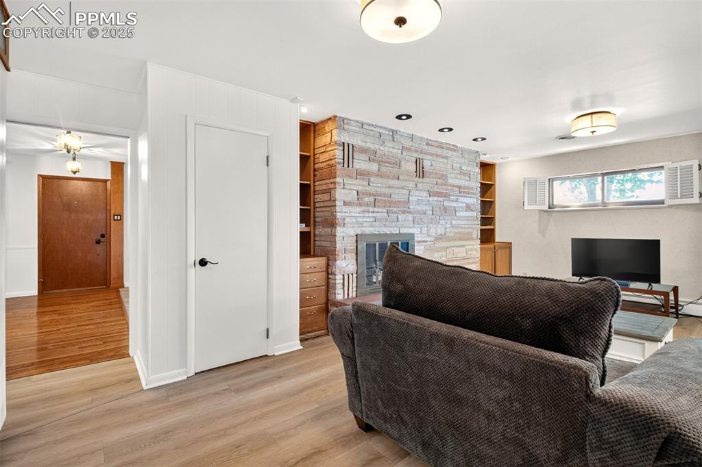 Image 12 of 43: Living area featuring light wood finished floors, built in features, recess