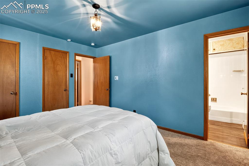 Image 13 of 43: Bedroom featuring carpet floors and ensuite bath