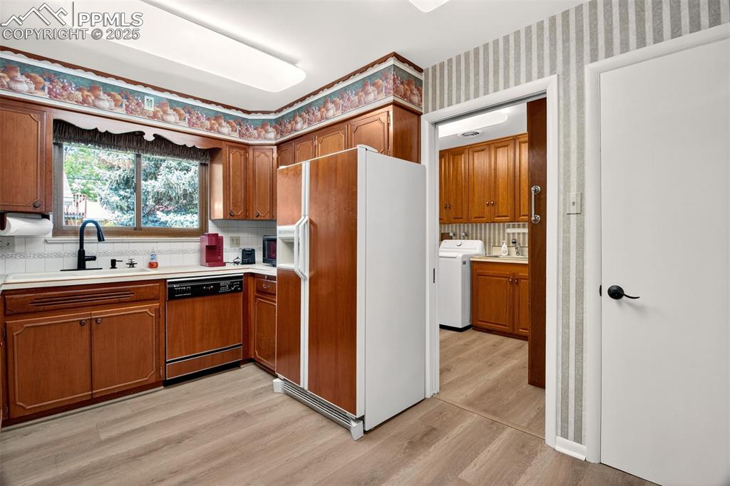 Image 2 of 43: Kitchen with white refrigerator with ice dispenser, light wood-style floors