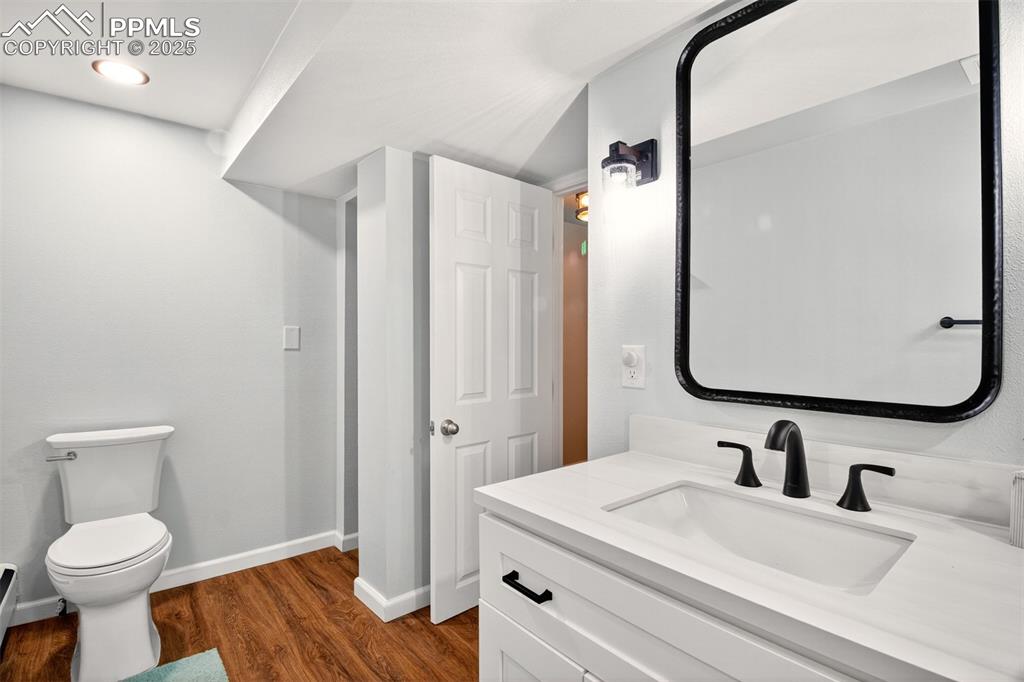 Image 30 of 43: Bathroom featuring vanity and wood finished floors