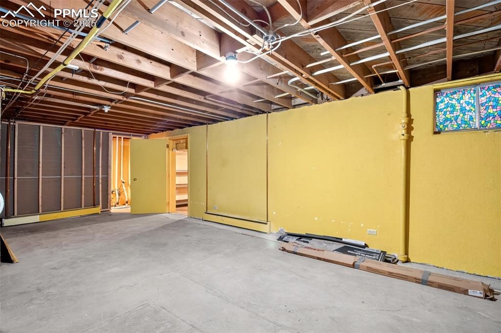 Image 32 of 43: Unfinished basement featuring baseboard heating