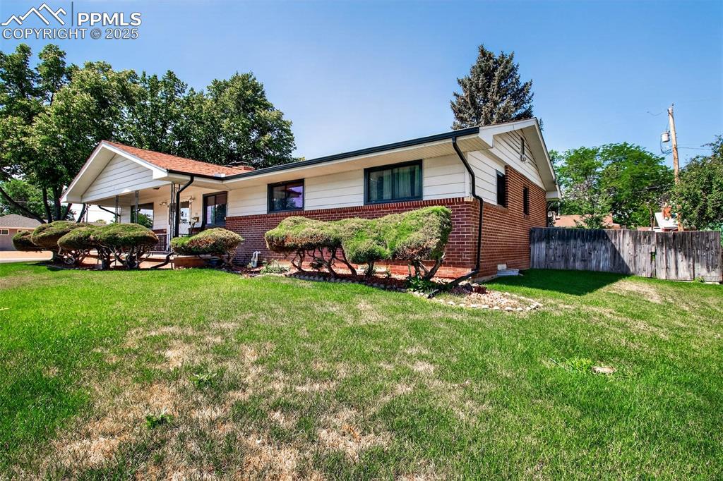 Image 40 of 43: Ranch-style house featuring brick siding and a porch