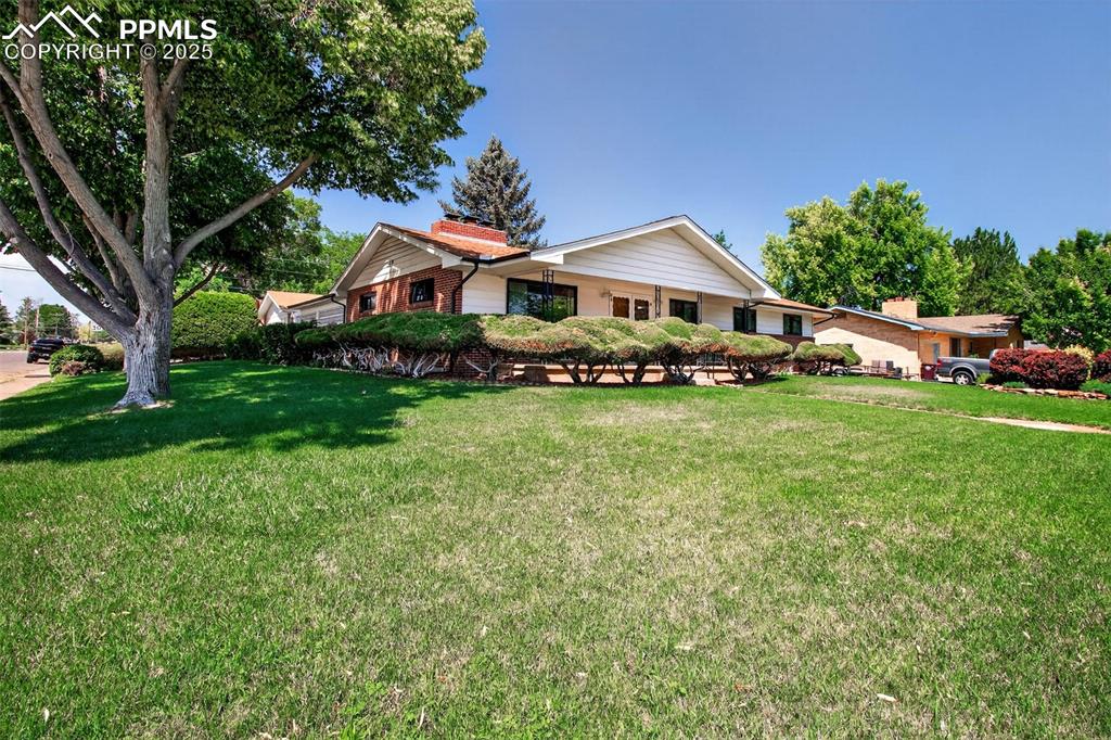 Image 41 of 43: Ranch-style house with a chimney and a front yard