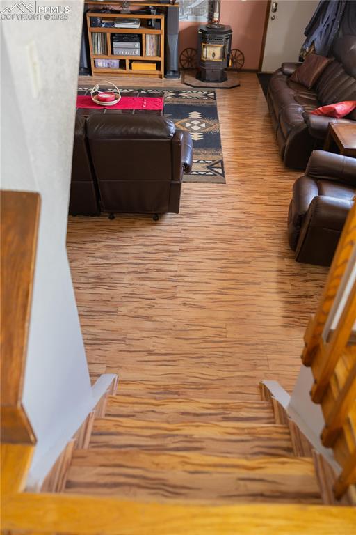 Image 21 of 49: Living room featuring light wood-style flooring and a wood stove