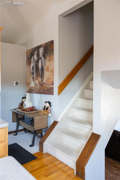 Image 27 of 49: Stairs featuring wood finished floors