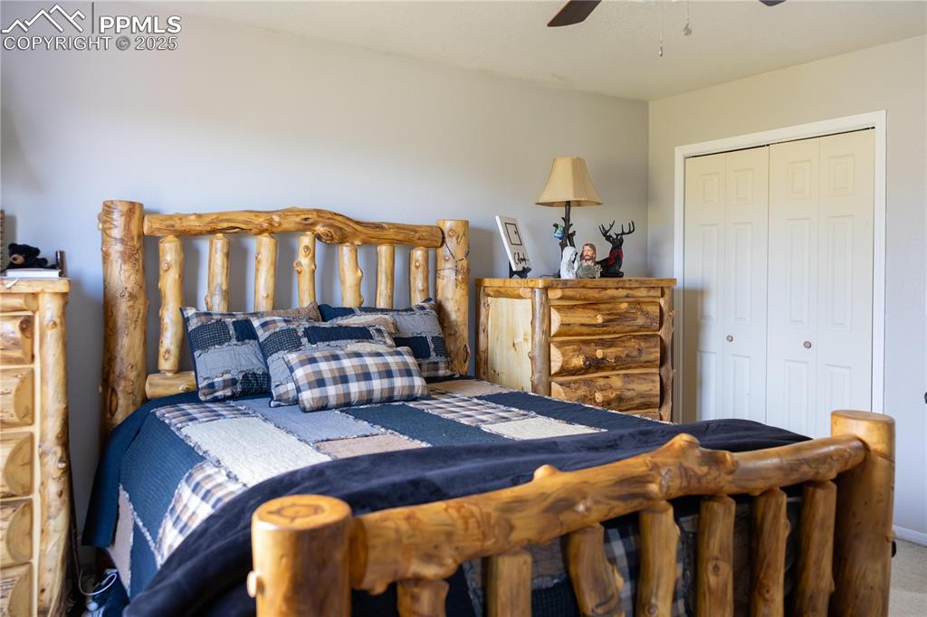 Image 28 of 49: Carpeted bedroom featuring a closet and ceiling fan