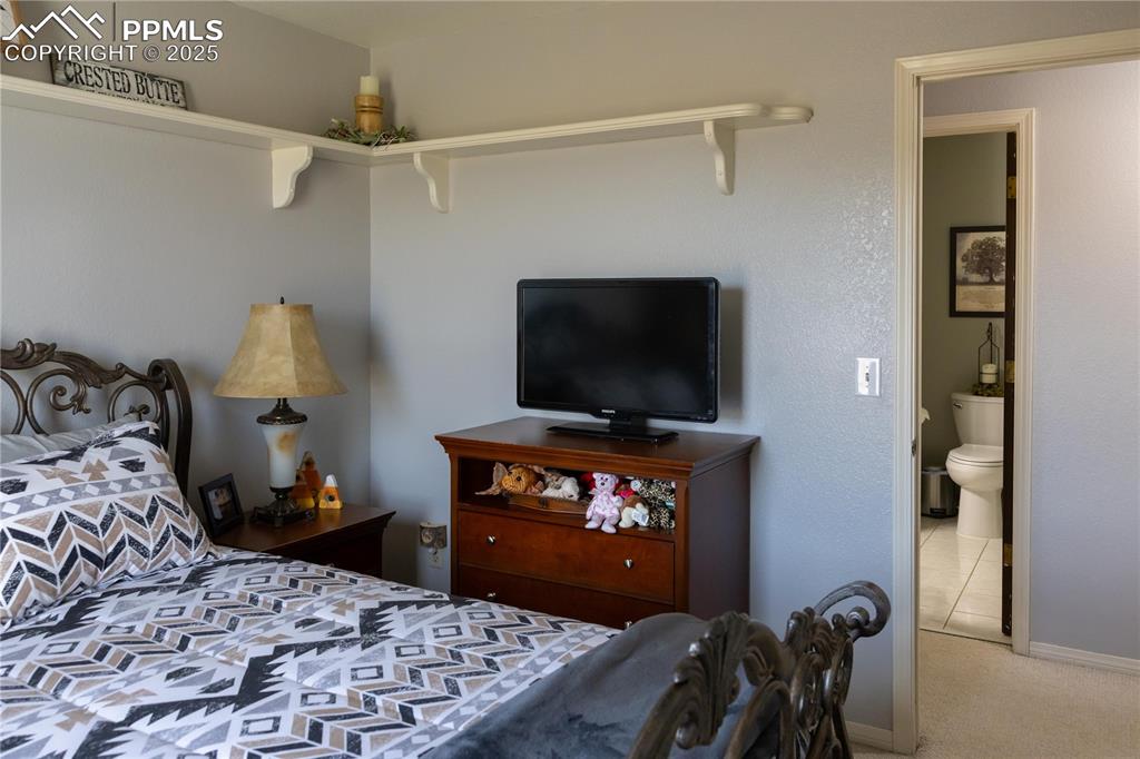 Image 36 of 49: Bedroom featuring carpet and baseboards