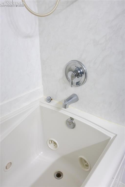 Image 38 of 49: Bathroom view of a combined bath / shower with jetted tub