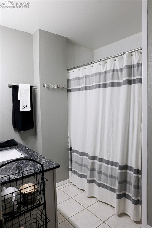 Image 40 of 49: Full bathroom featuring light tile patterned floors and a shower with curta