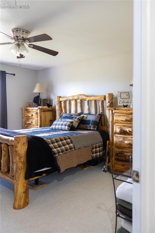 Image 41 of 49: Carpeted bedroom featuring ceiling fan