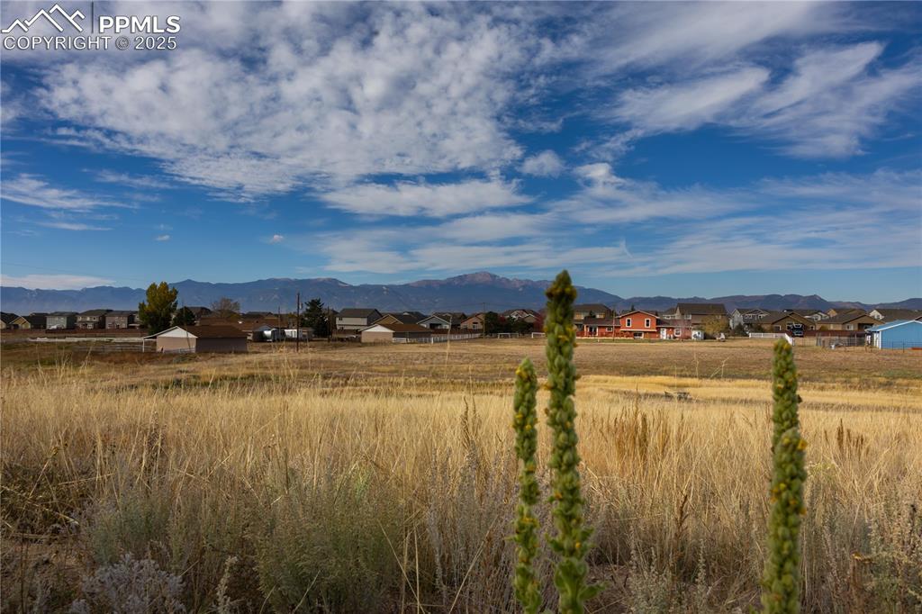Image 47 of 49: View of mountain background featuring nearby suburban area