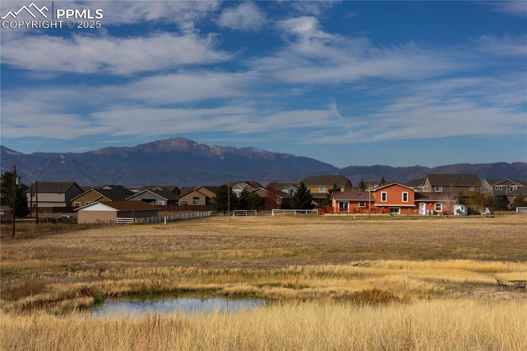 Image 48 of 49: Mountain view featuring nearby suburban area and a large body of water
