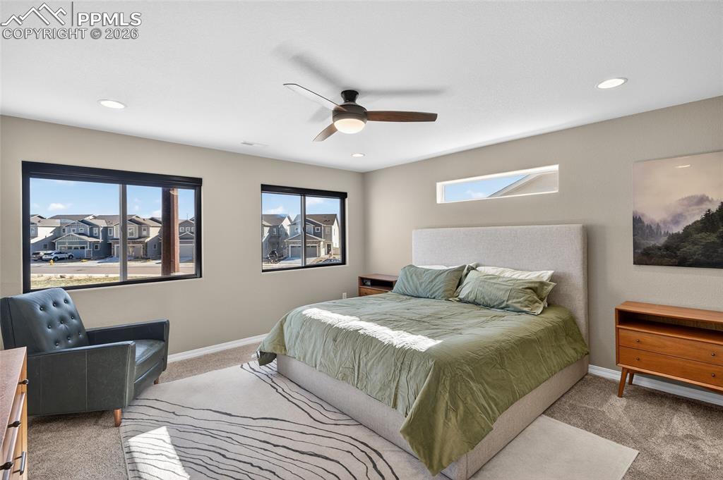 Image 17 of 38: Bedroom with carpet flooring, ceiling fan, and recessed lighting