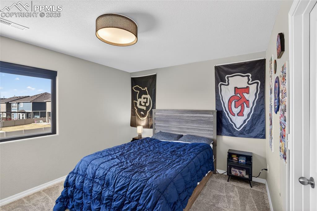 Image 24 of 38: Bedroom with light carpet and baseboards