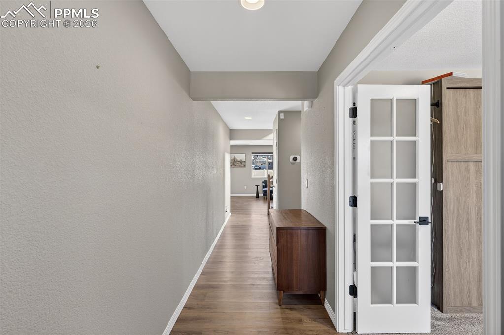 Image 27 of 38: Corridor featuring dark wood-type flooring and recessed lighting