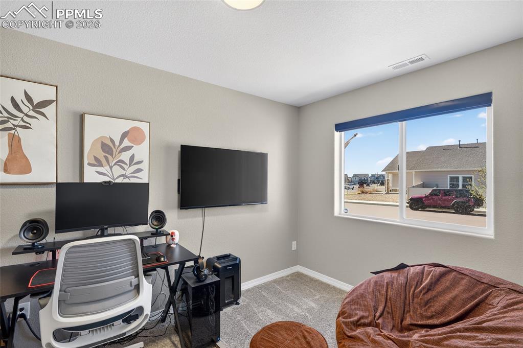 Image 29 of 38: Office space featuring light colored carpet and baseboards