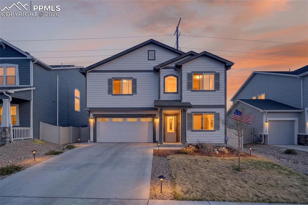 Image 3 of 38: View of front of home with concrete driveway and a garage