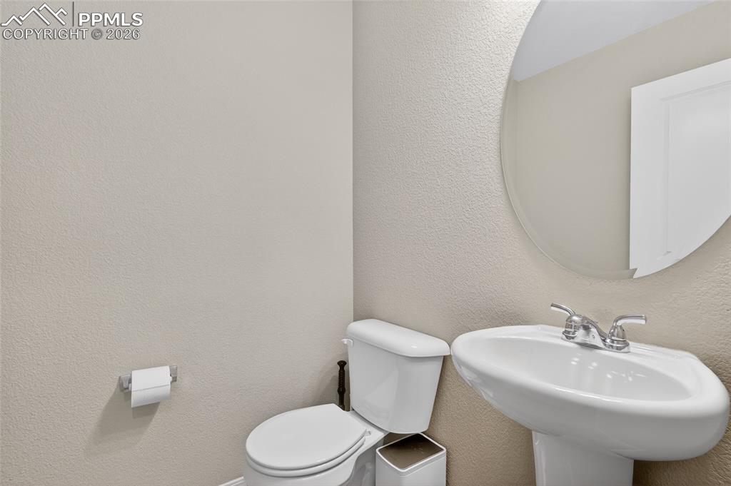 Image 30 of 38: Bathroom with toilet and a sink