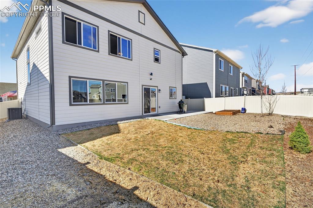 Image 32 of 38: Back of house featuring a patio area and a fenced backyard