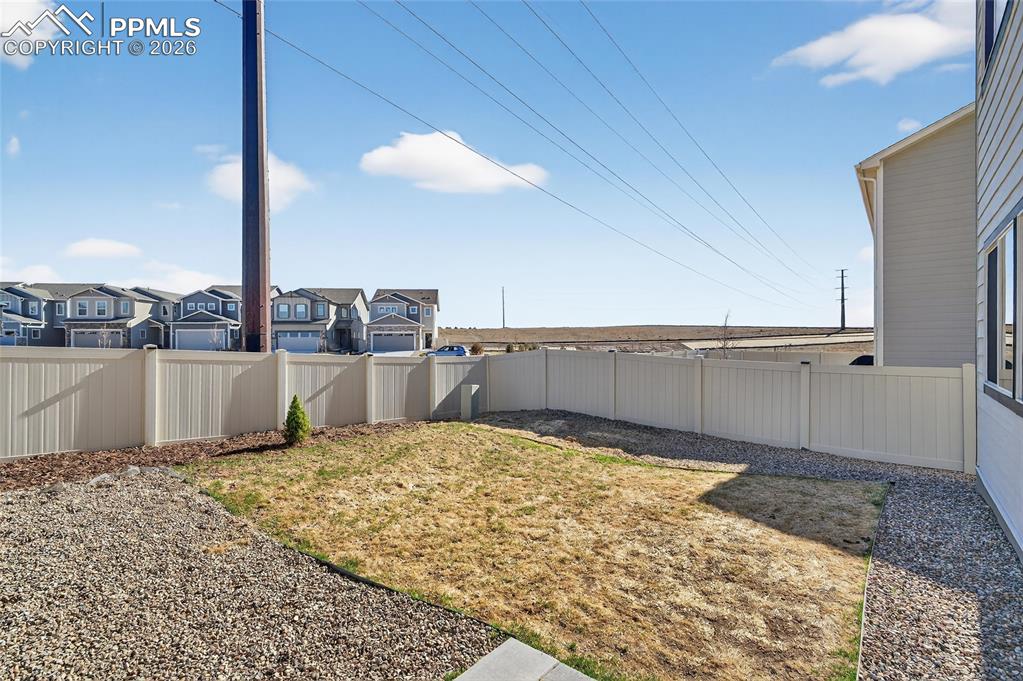 Image 33 of 38: Fenced backyard featuring a residential view