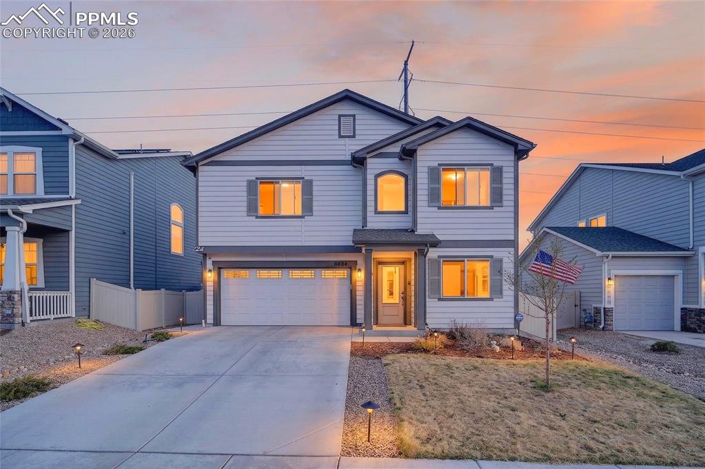 Image 35 of 38: View of front of property featuring concrete driveway and a garage