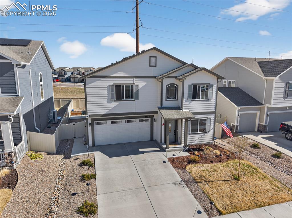Image 4 of 38: Traditional-style home featuring a residential view, driveway, a garage, an