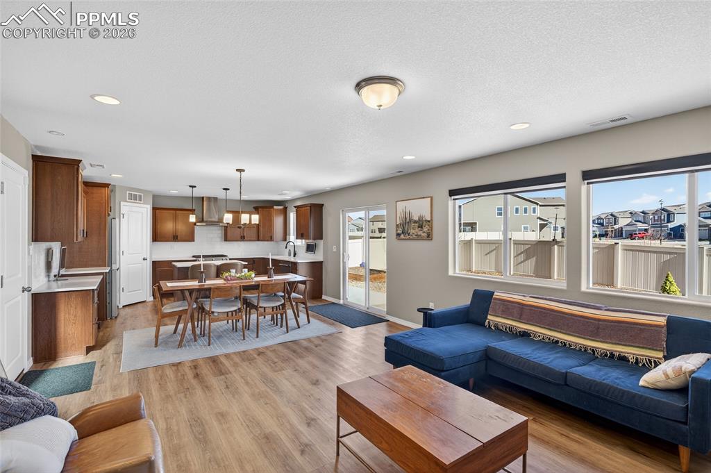 Image 7 of 38: Living area featuring light wood-style floors and recessed lighting