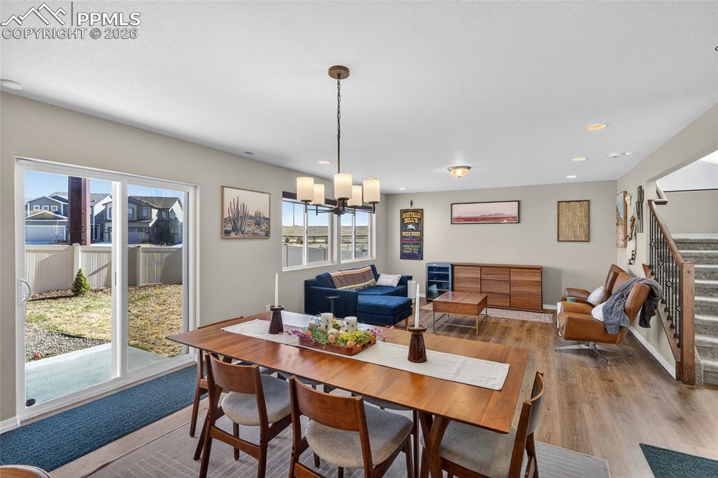 Image 8 of 38: Dining room featuring wood finished floors and suspended lighting