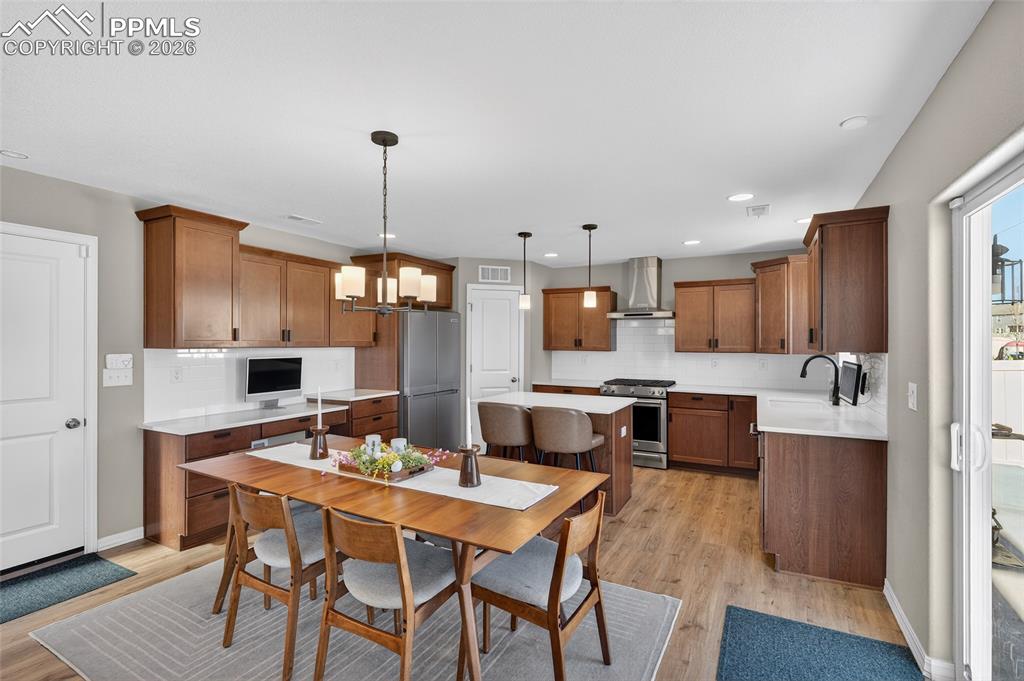 Image 9 of 38: Dining space featuring light wood-style floors and a chandelier
