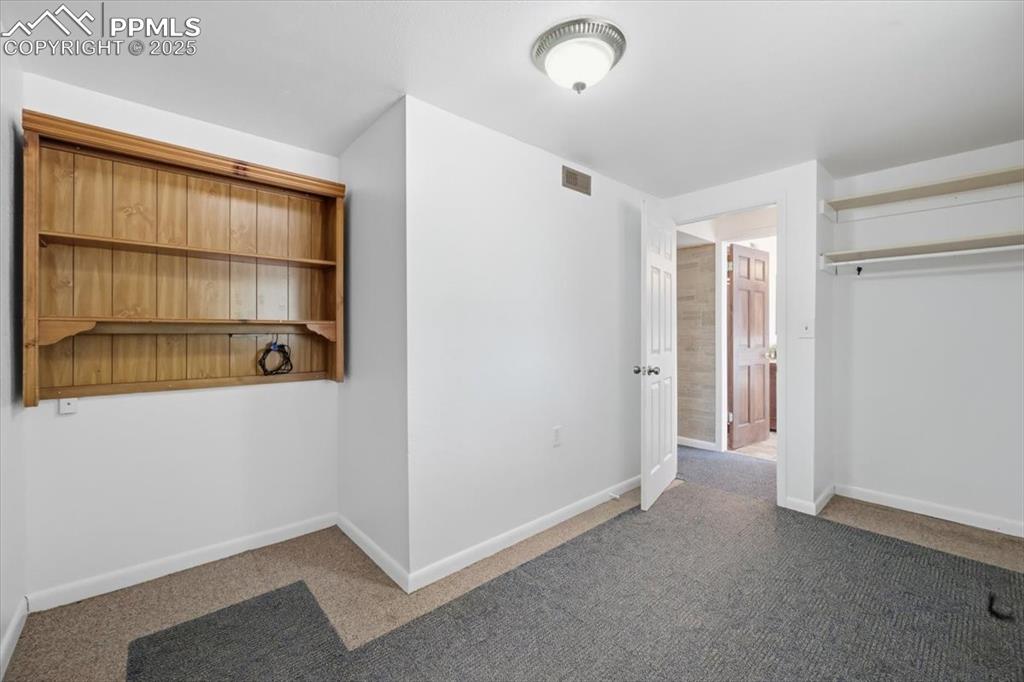 Image 16 of 26: room featuring carpet floors and baseboards