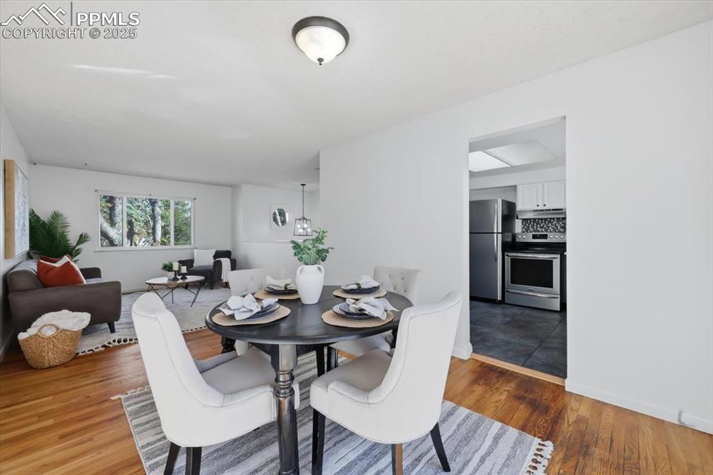 Image 5 of 26: Dining space featuring wood finished floors and baseboards