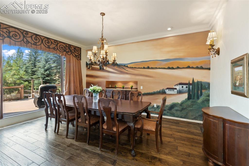 Image 18 of 50: Formal Dining room with a beautiful mural and built in cabinetry.