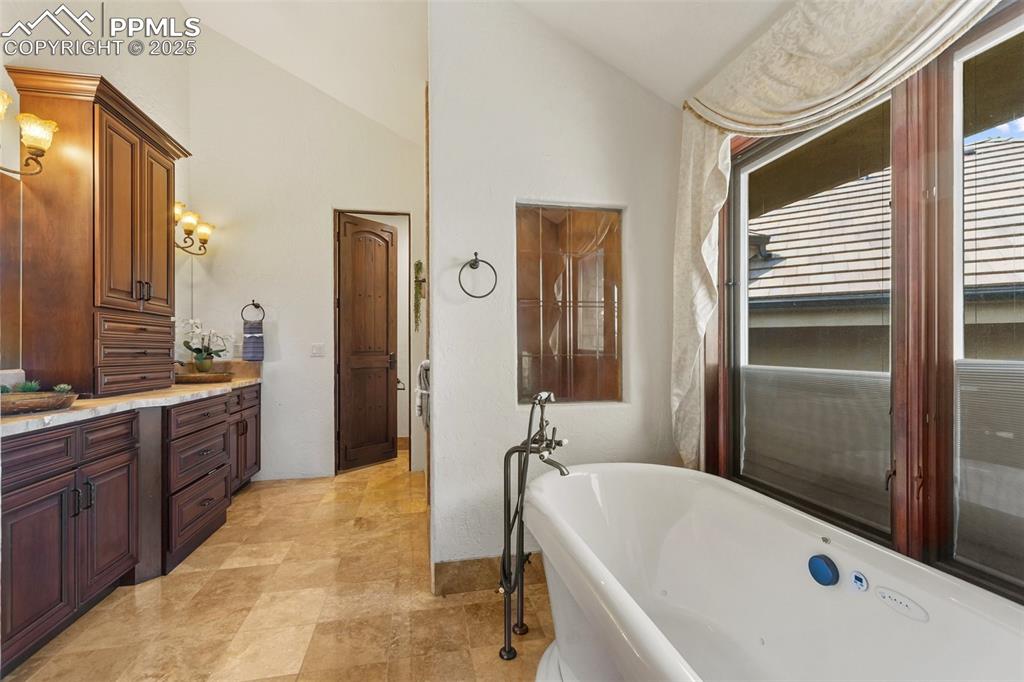 Image 26 of 50: Stand alone shower with a separate soaking tub and jack and jill sinks.
