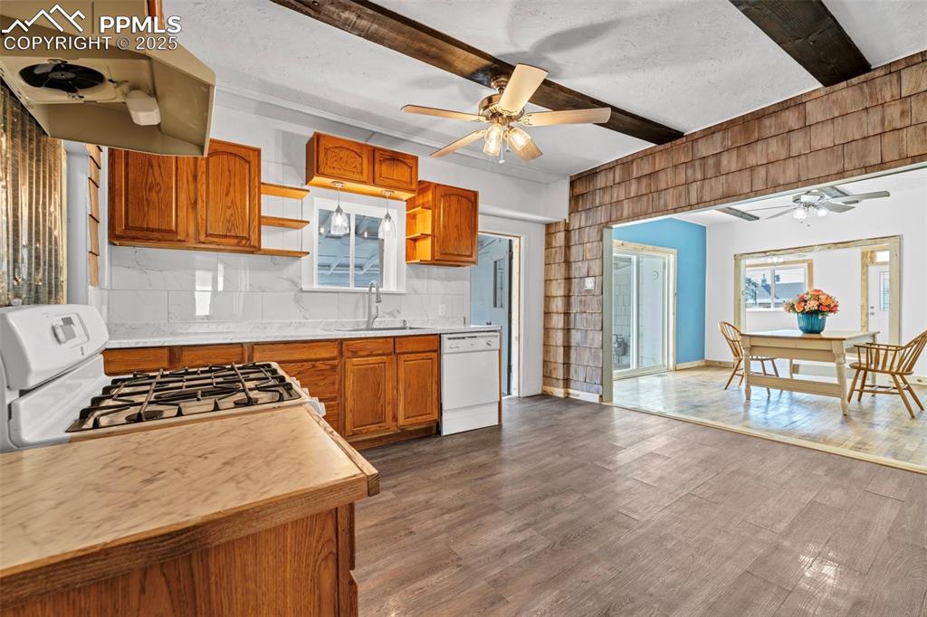 Image 14 of 34: Kitchen opens to Dining Room and walks out to Screened in Porch
