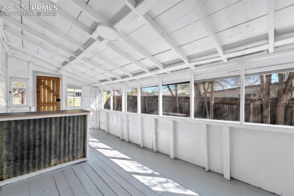 Image 15 of 34: Screened In Porch with exit to backyard