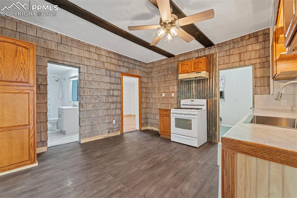 Image 17 of 34: Kitchen with access to main bathroom (left), Primary Bedroom, and Laundry R