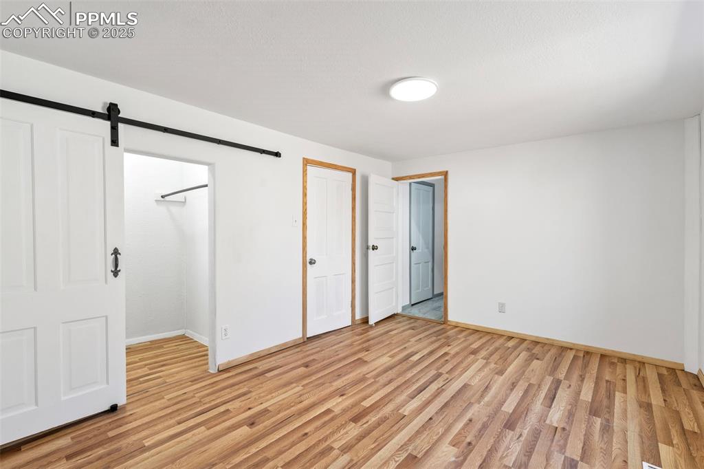 Image 20 of 34: Barn door in Primary Bedroom and Direct Access to Full Bathroom