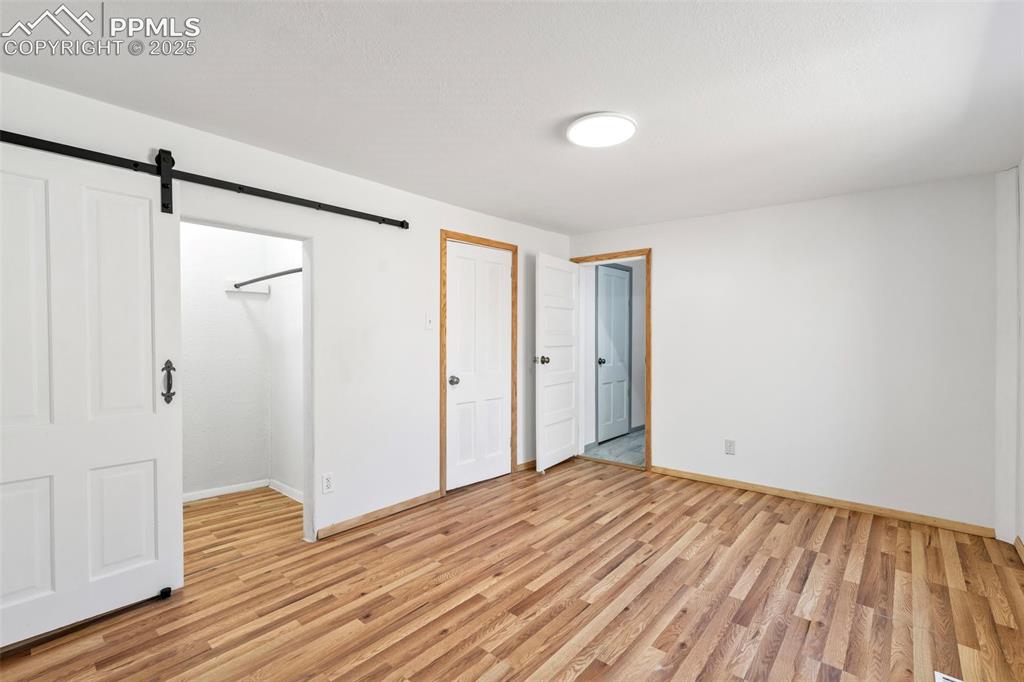 Image 20 of 34: Barn door in Primary Bedroom and Direct Access to Full Bathroom