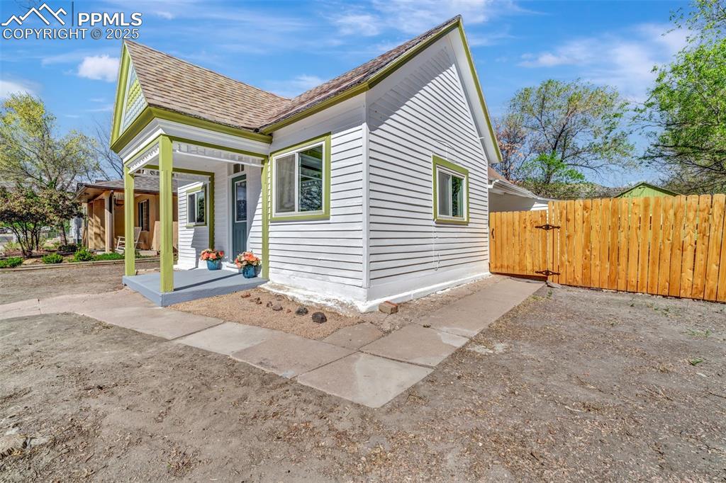 Image 32 of 34: Some landscaping started surrounding the newly painted porch/front entry