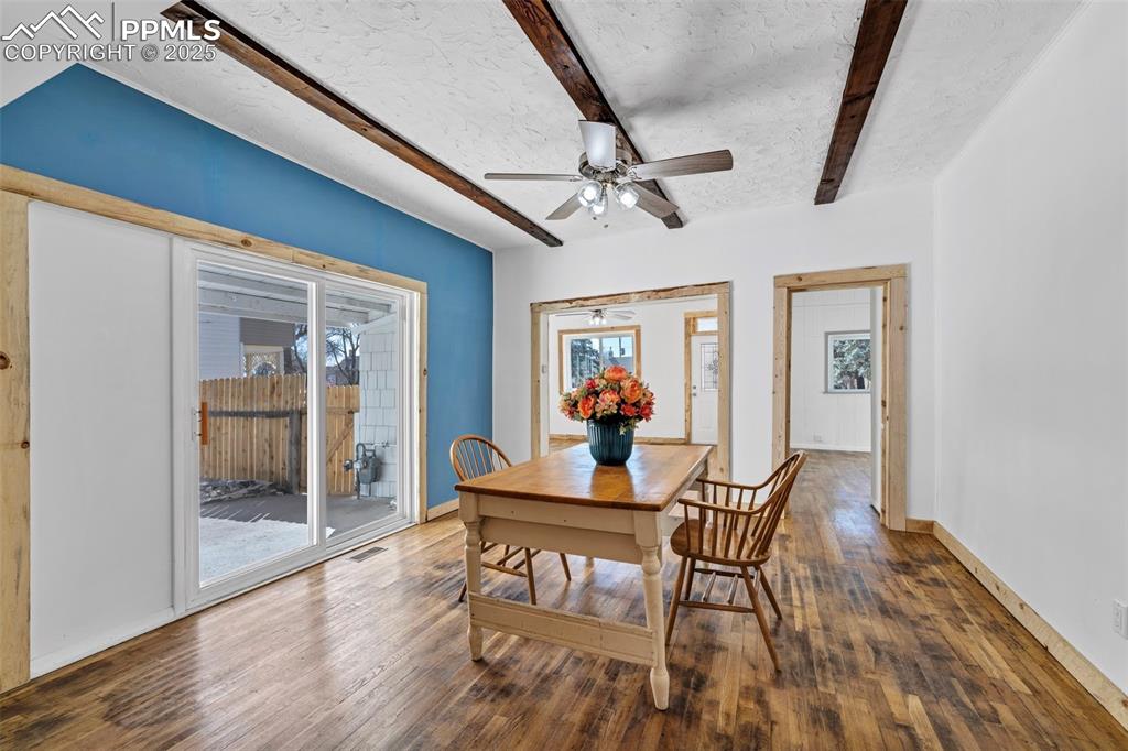 Image 7 of 34: Beams and original wood floors in Dining Room, with access to White bedroom