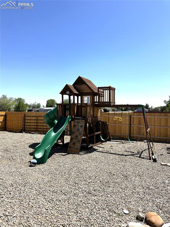 Image 19 of 20: Play set in the back yard stays with the home
